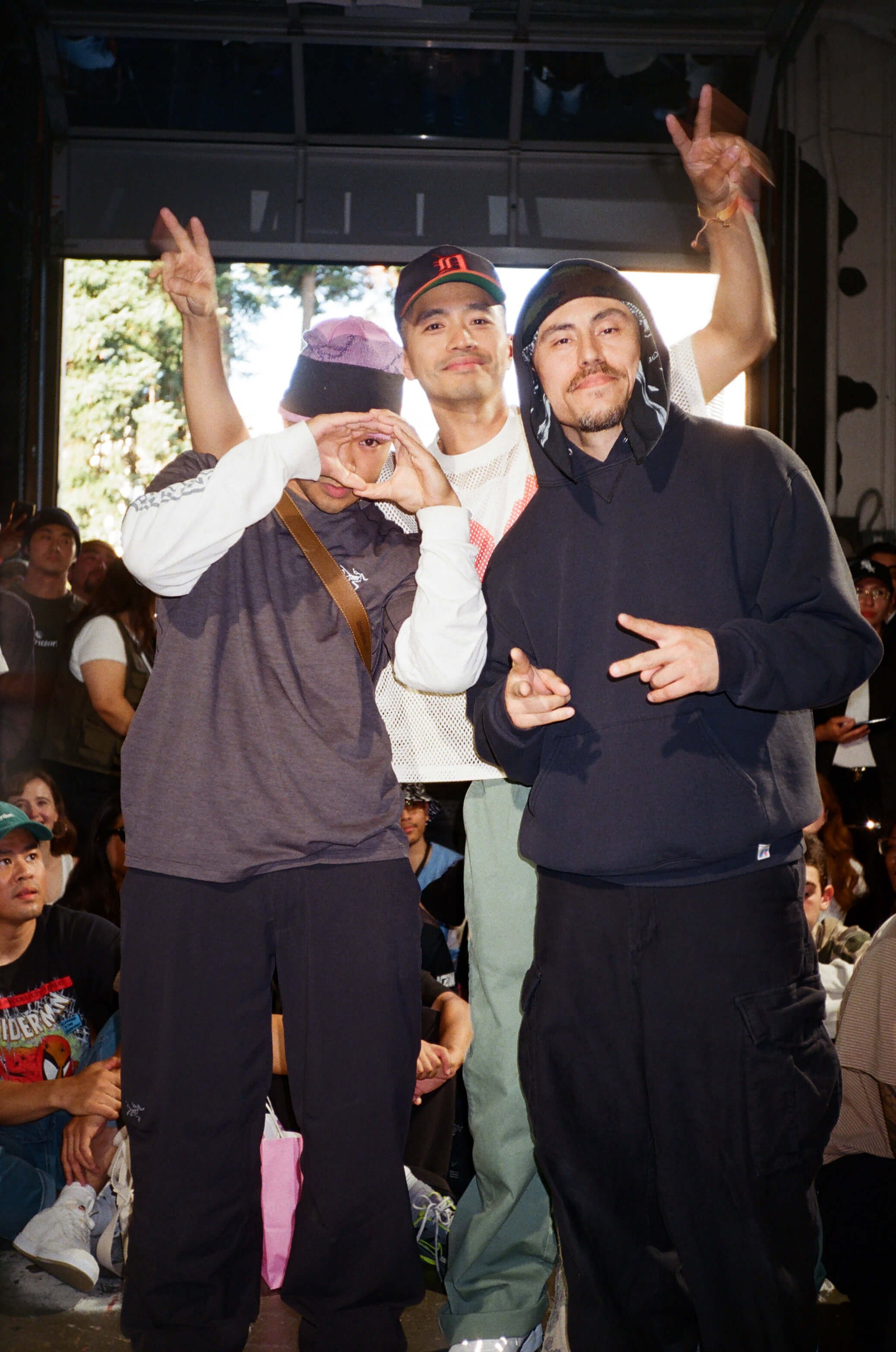 Three dancers on stage in front of a seated crowd at New Birth 2025.